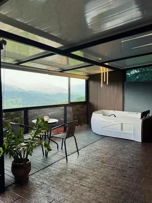 a bedroom with a tub and a table and chairs at Altos del Silencio in San Rafael