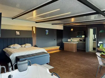 a bedroom with a bed and a kitchen in a room at Altos del Silencio in San Rafael