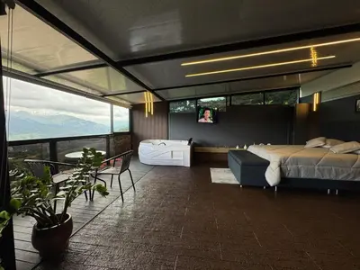 a bedroom with a bed and a view of the mountains at Altos del Silencio in San Rafael