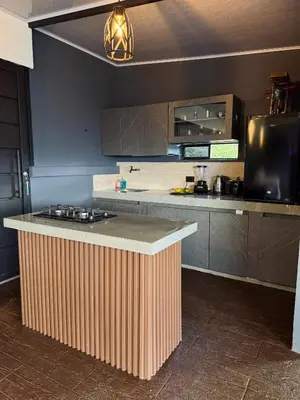 a kitchen with a wooden island in the middle at Altos del Silencio in San Rafael