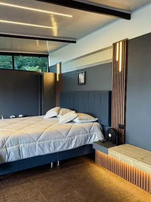 a bedroom with a large bed and a window at Altos del Silencio in San Rafael