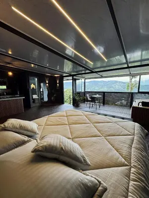 a large bed in a room with a view at Altos del Silencio in San Rafael