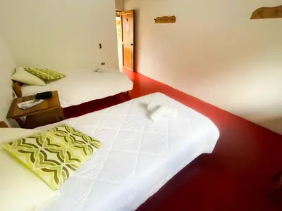 a hotel room with two beds and a mirror at Las Tangaras Reserve
