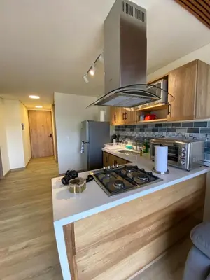 a kitchen with a stove and a counter top at San Telmo Apartment with Jacuzzy in Guatapé