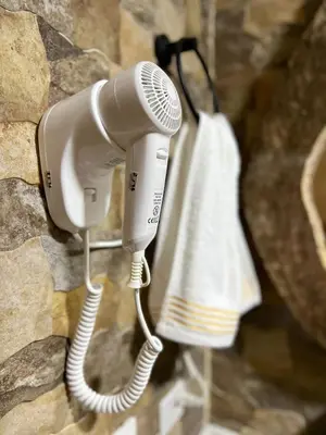 a blow dryer hanging on a wall with a towel at Acogedor en parque principal Guatape con Jacuzzi in Guatapé