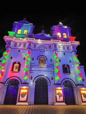 a building with christmas lights on it at Acogedor en parque principal Guatape con Jacuzzi in Guatapé