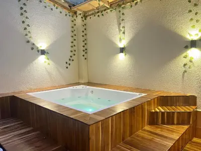 a jacuzzi tub in a room with lights at Acogedor en parque principal Guatape con Jacuzzi in Guatapé