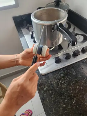 a woman is stirring a pot on a stove at Apartment 202 Garden Shelter - 10 min to Balandú Park in Jardin