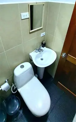 a bathroom with a toilet and a sink at Apartment 202 Garden Shelter - 10 min to Balandú Park in Jardin