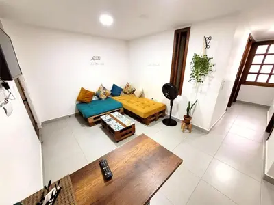 a living room with a couch and a table at Apartment 202 Garden Shelter - 10 min to Balandú Park in Jardin