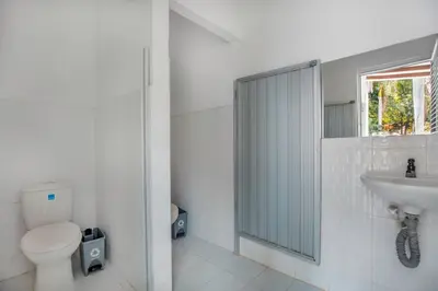 a white bathroom with a toilet and a sink at Fina Hotel La Morenita in Santa Fe de Antioquia