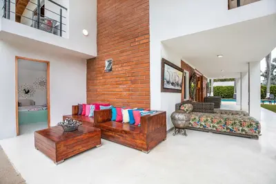 a living room with two couches and a brick wall at Fina Hotel La Morenita in Santa Fe de Antioquia