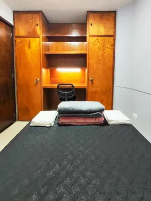 a room with a bed with a chair and a desk at Casa Linda Zona Rosa Buenos Aires, Natural Garden in Medellín