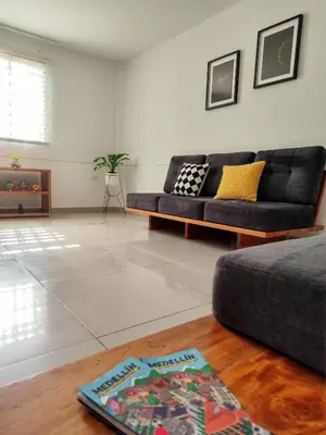 a living room with a couch and a table at Casa Linda Zona Rosa Buenos Aires, Natural Garden in Medellín