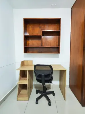 a desk with a chair in front of a wall at Casa Linda Zona Rosa Buenos Aires, Natural Garden in Medellín