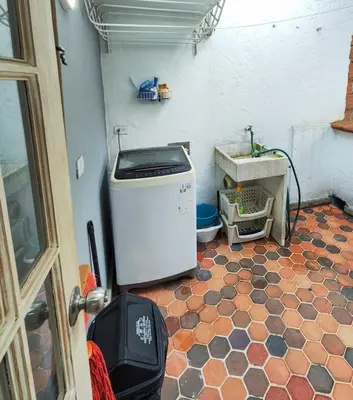 a laundry room with a washer and dryer on a floor at Modern Loft in Zona Rosa Buenos Aires WiFi 500Mb in Medellín