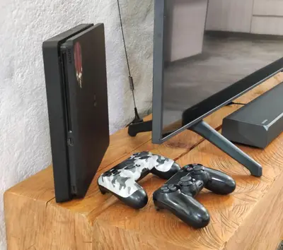 a computer monitor and two video game controllers on a table at Modern Loft in Zona Rosa Buenos Aires WiFi 500Mb in Medellín