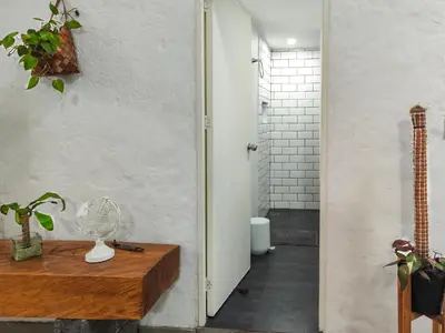 a room with a wooden table with a glass vase on it at Modern Loft in Zona Rosa Buenos Aires WiFi 500Mb in Medellín