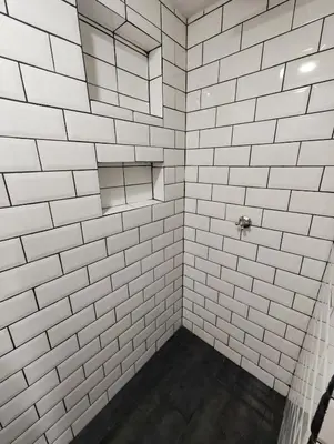 a bathroom with white tiled walls and a shower at Modern Loft in Zona Rosa Buenos Aires WiFi 500Mb in Medellín