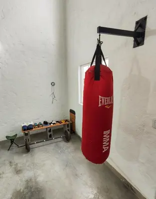 a red punching bag hanging from a wall in a room at Modern Loft in Zona Rosa Buenos Aires WiFi 500Mb in Medellín
