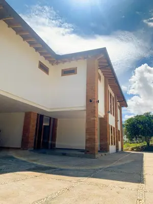 a large white building with a brick at AMAZING EL POBLADO VIEWs-MODERN VILLA in Envigado