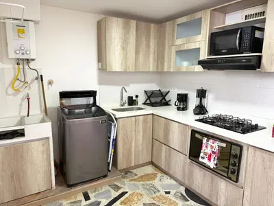 a small kitchen with a stove and a refrigerator at Apartamento para 5 personas en Laureles, Estadio in Estación El Salto