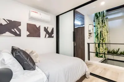 a bedroom with a white bed and a window at Manila Luxury Suites 301 in Medellín