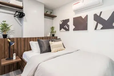 a bedroom with a bed with a wooden headboard at Manila Luxury Suites 301 in Medellín