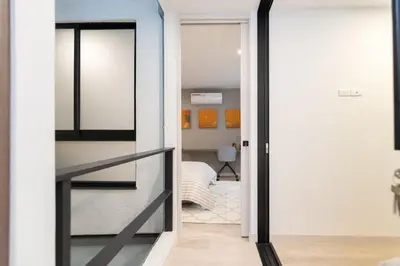 a room with a glass door leading into a bedroom at Manila Luxury Suites 301 in Medellín