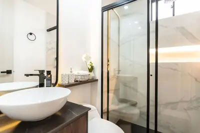 a bathroom with a white sink and a shower at Manila Luxury Suites 301 in Medellín