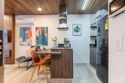 a kitchen with a table and chairs in a room at Manila Luxury Suites 301 in Medellín