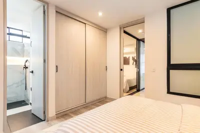 a bedroom with a bed and a sliding glass door at Manila Luxury Suites 301 in Medellín
