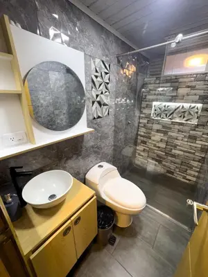 a bathroom with a toilet and a sink and a shower at Casa con vista a la montaña en Manizales in Manizales
