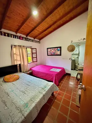 a bedroom with two beds in a room at Villa Amparo Casa Finca in Rionegro
