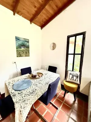 a dining room with a table and chairs and a window at Villa Amparo Casa Finca in Rionegro