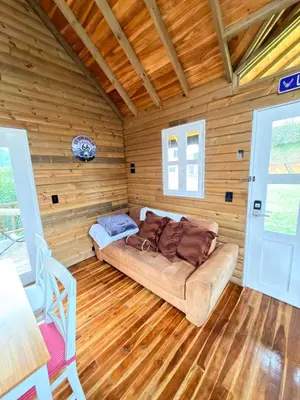 a room with a couch in a log cabin at Wooden House in Rionegro