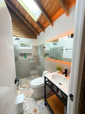 a bathroom with a toilet and a sink at Wooden House in Rionegro