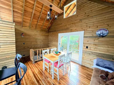 a dining room with a table and chairs in a cabin at Wooden House in Rionegro