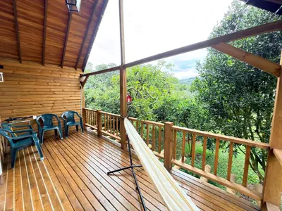 a wooden deck with a table and chairs on it at Wooden House in Rionegro