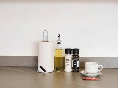 a table with bottles of oils and a roll of paper towels at Engaging Loft with Balcony in Laureles in Medellín