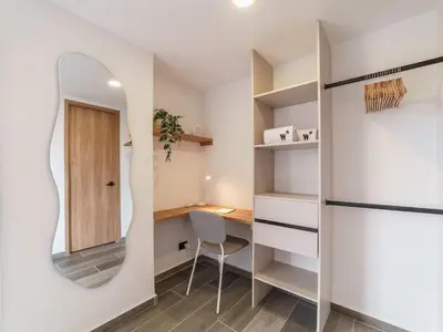 a room with a mirror and a desk with a chair at Engaging Loft with Balcony in Laureles in Medellín