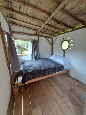 a bedroom with a bed in a room with a window at Familia Verde Eco Hostal in San Carlos