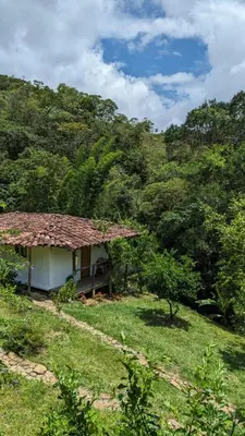 a small house in the middle of a field at Familia Verde Eco Hostal in San Carlos