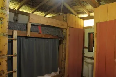 a bathroom with a shower curtain and a toilet at Familia Verde Eco Hostal in San Carlos