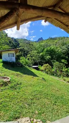 a view of a field of grass with a house at Familia Verde Eco Hostal in San Carlos