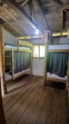 an empty room with two bunk beds and a window at Familia Verde Eco Hostal in San Carlos