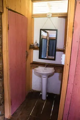 a bathroom with a sink and a mirror at Familia Verde Eco Hostal in San Carlos