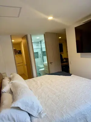 a bedroom with a large bed with white sheets at Eternal Springs 8pp, 3br, 2bt, 3acs, Pool, Jacuzzi in Medellín