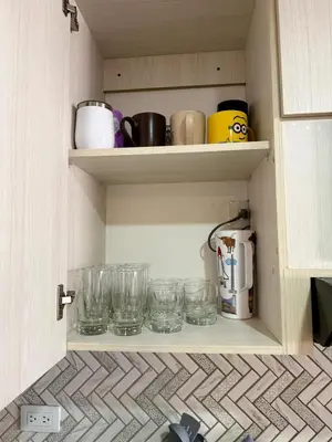 a cupboard with glasses and other items on it at Eternal Springs 8pp, 3br, 2bt, 3acs, Pool, Jacuzzi in Medellín