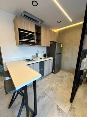 a kitchen with a table and a refrigerator at Apartaestudio in Medellín